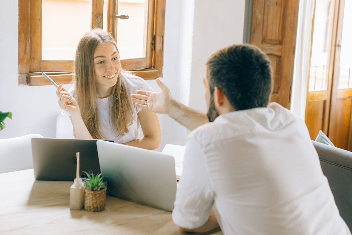 Free Man and Woman Discussing Work Stock Photo