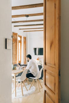 Man working in a stylish home office, showcasing a modern remote work environment.