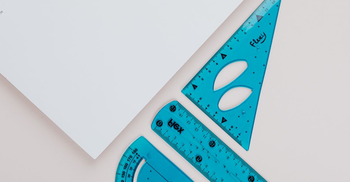 Close-up image of blue geometry tools on white background for educational use.