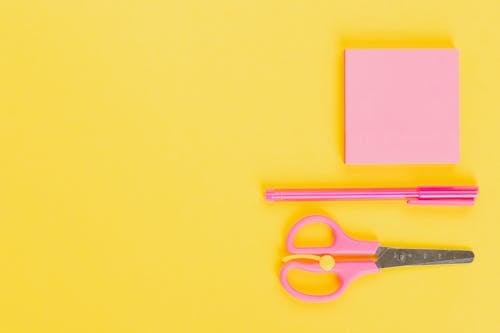 Pink School Supplies on Yellow Surface