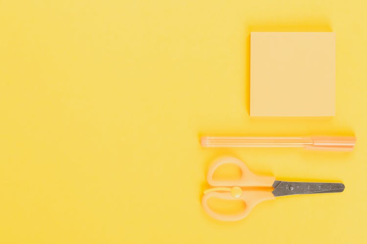 Yellow Sticky Note And Pen Beside A Scissor