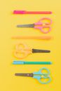 Orange Handled Scissors Beside Blue and Gray Ballpoint Pen