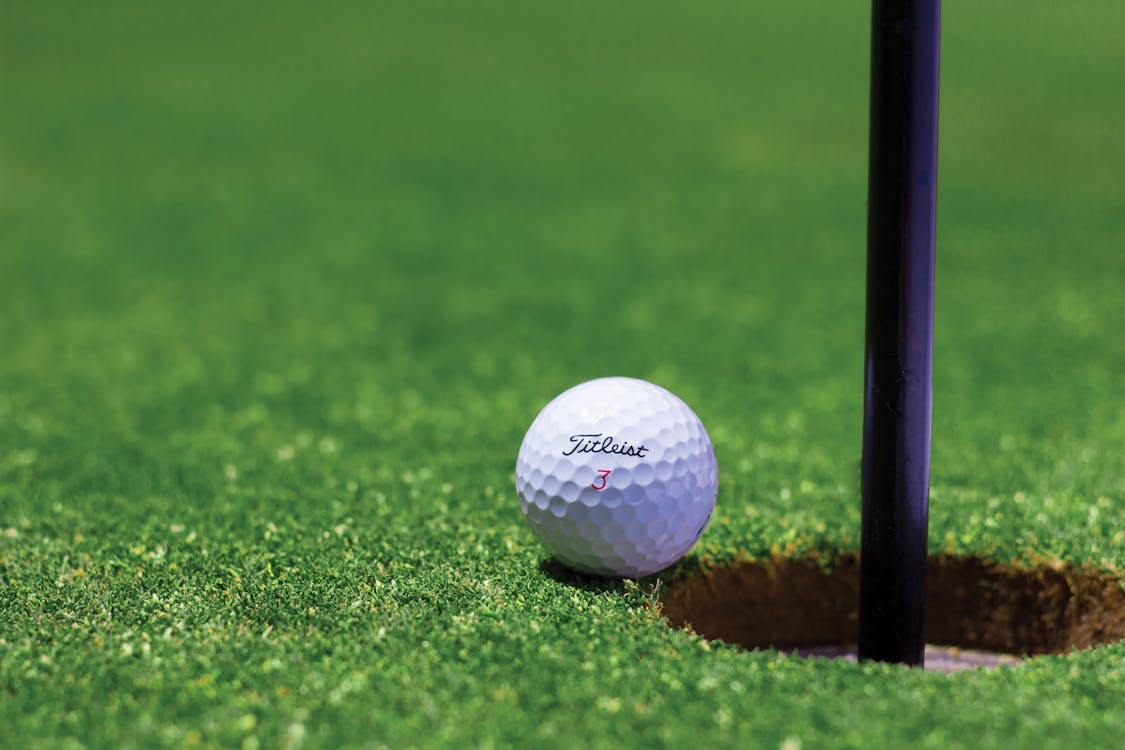A golf ball near a hole