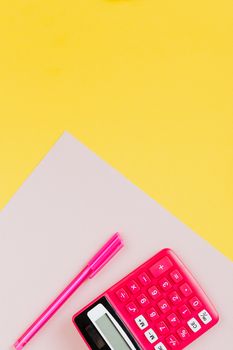 A vibrant pink calculator and pen set on a striking yellow background, perfect for educational themes.