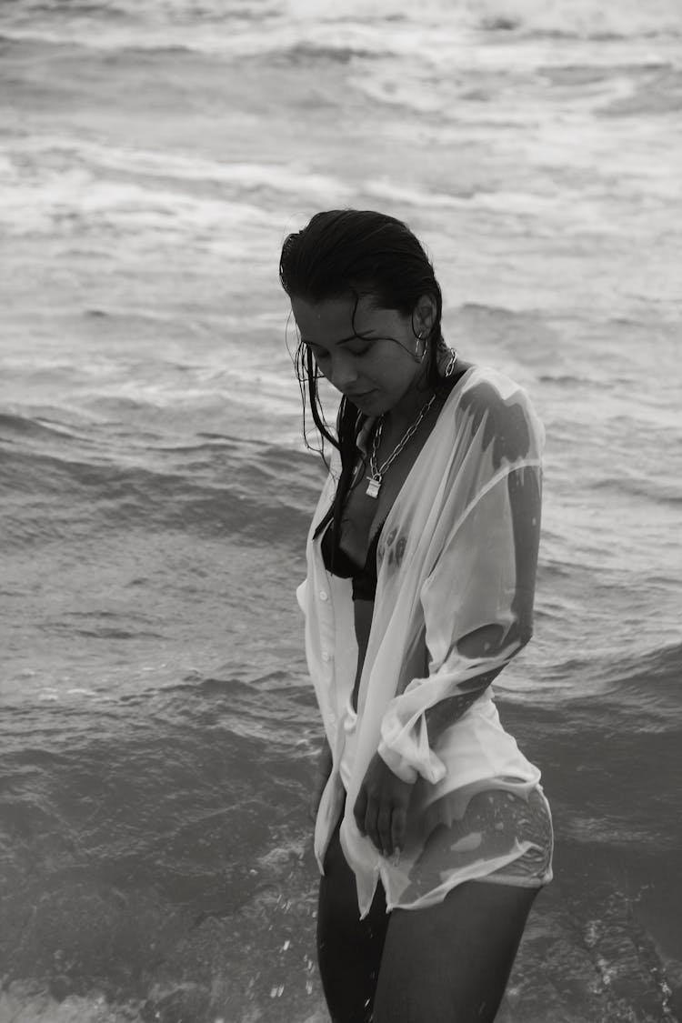 Young Woman In Wet Shirt Standing In Sea