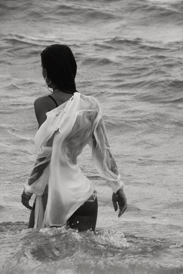 Slim Woman In Wet Shirt Standing In Water