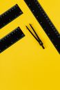 Black and Silver Ruler on Yellow Surface