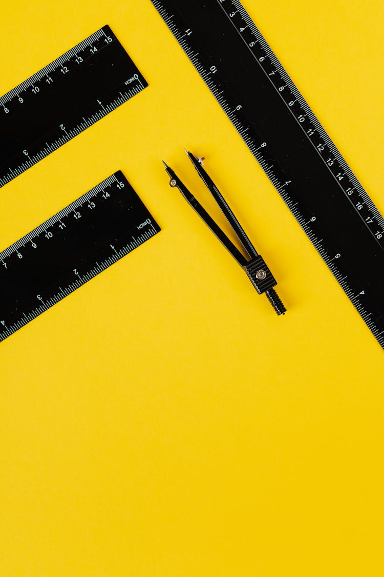 Black Measuring Tools For School On Yellow Background 