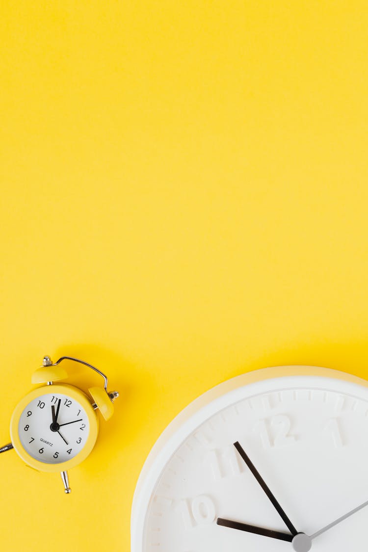 Clocks On Yellow Background