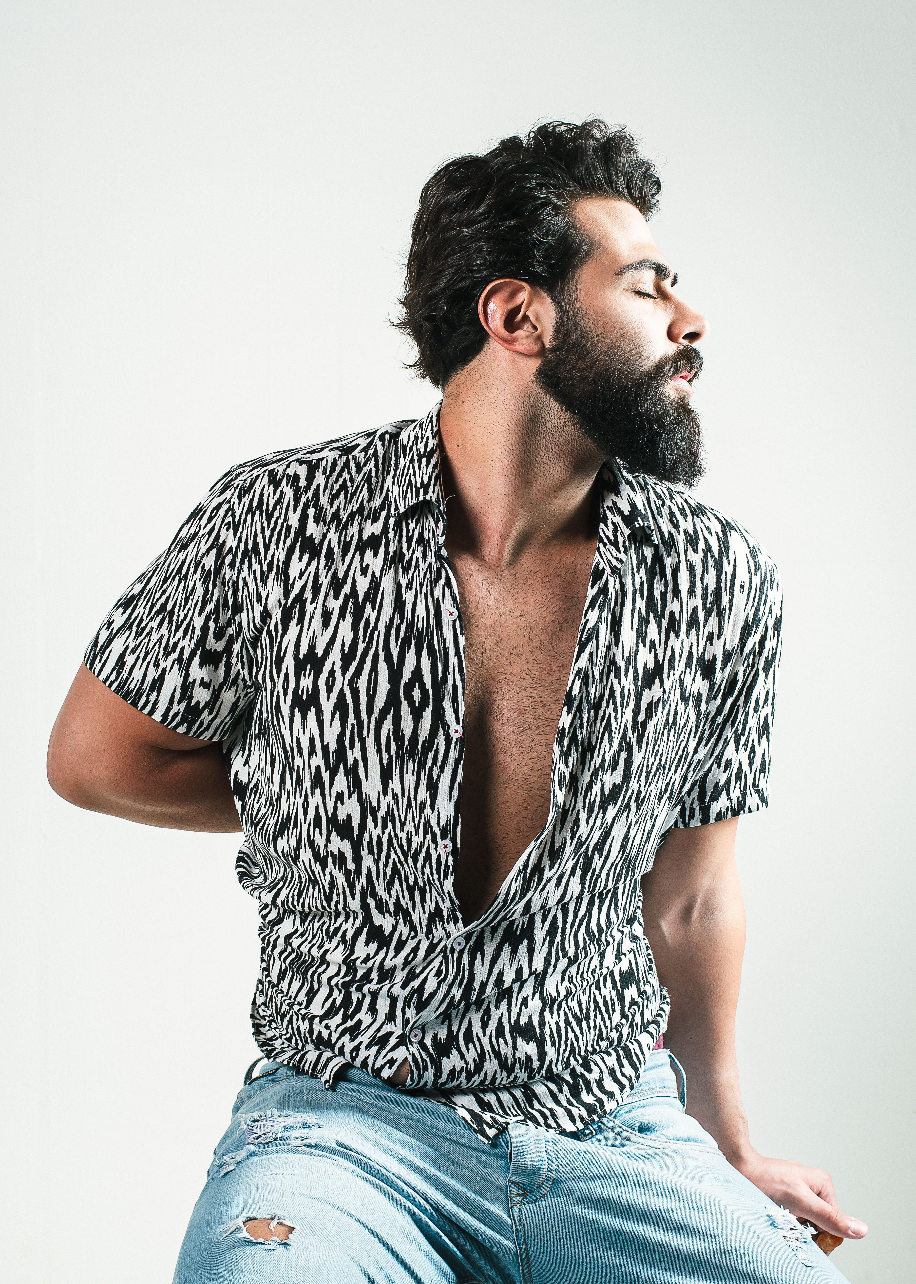 Stylish ethnic bearded man in striped shirt · Free Stock Photo