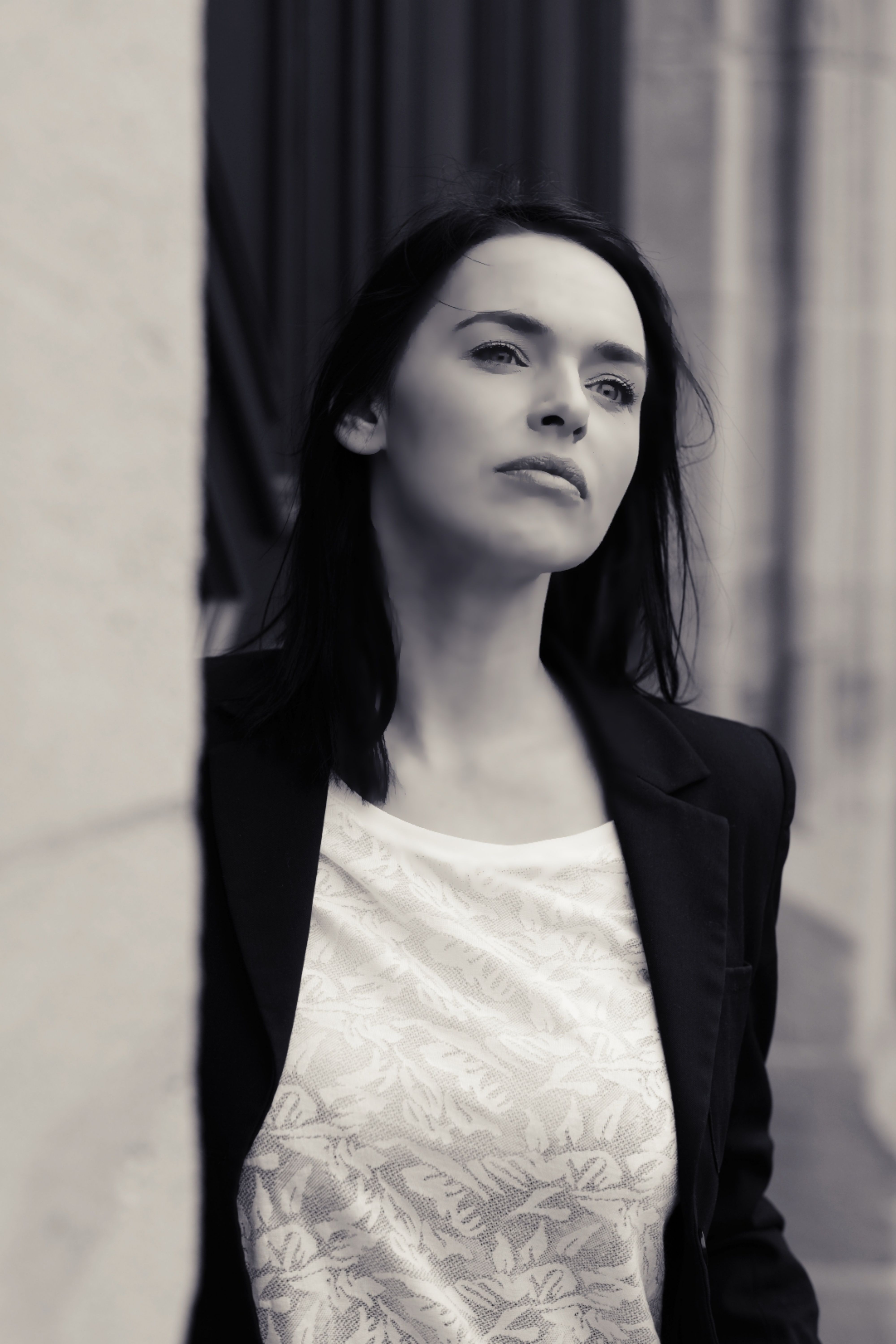 Stylish black and white portrait of a woman in a blazer, exuding elegance and confidence.