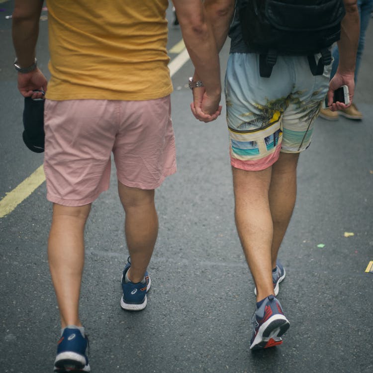 Two Men Holding Hands While Walking · Free Stock Photo