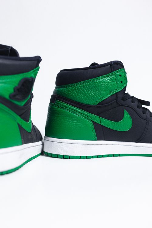 Free Close-up of high-top green and black sneakers with prominent logo design. Stock Photo