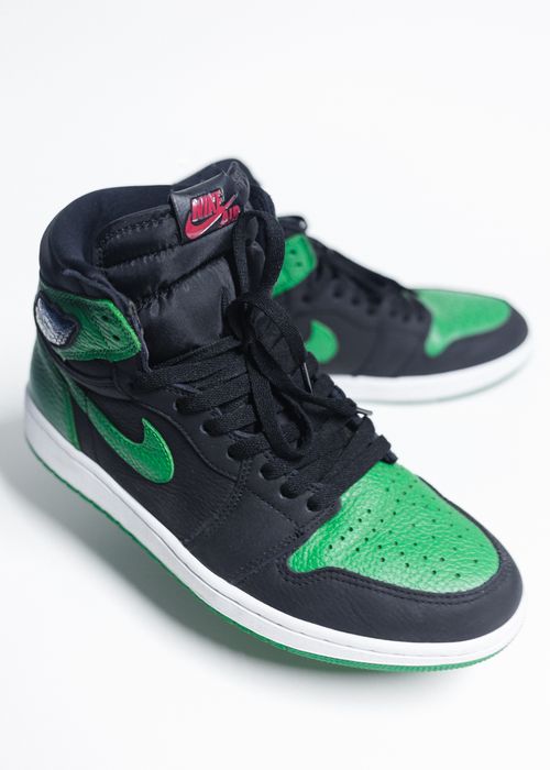 Free A close-up image of high-top green and black sneakers with a prominent Swoosh logo, perfect for product advertising. Stock Photo