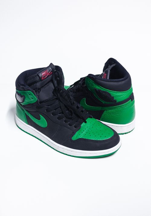 Free Stylish black and green sneakers with a sleek design against a plain white background. Stock Photo