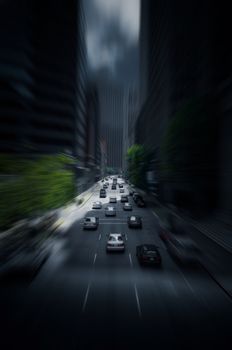 Moody city highway traffic with motion blur and dark skyscrapers, depicting urban life.