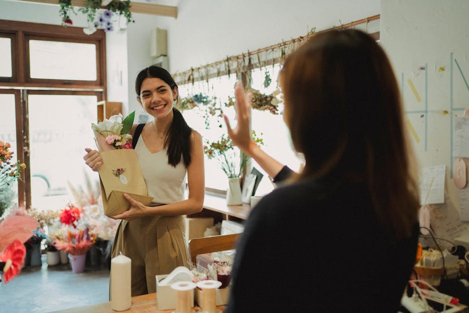 Happy customer and florist in flower shop