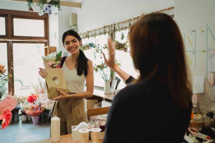 Happy Customer And Florist In Flower Shop