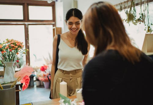 Free Happy woman visiting floral shop and buying bouquet Stock Photo