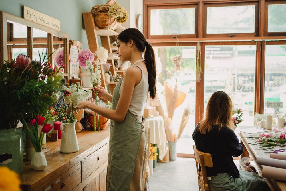 Florists at work inside the warm wooden boutique