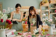 两名女花艺师在舒适的工作室里愉快地插花