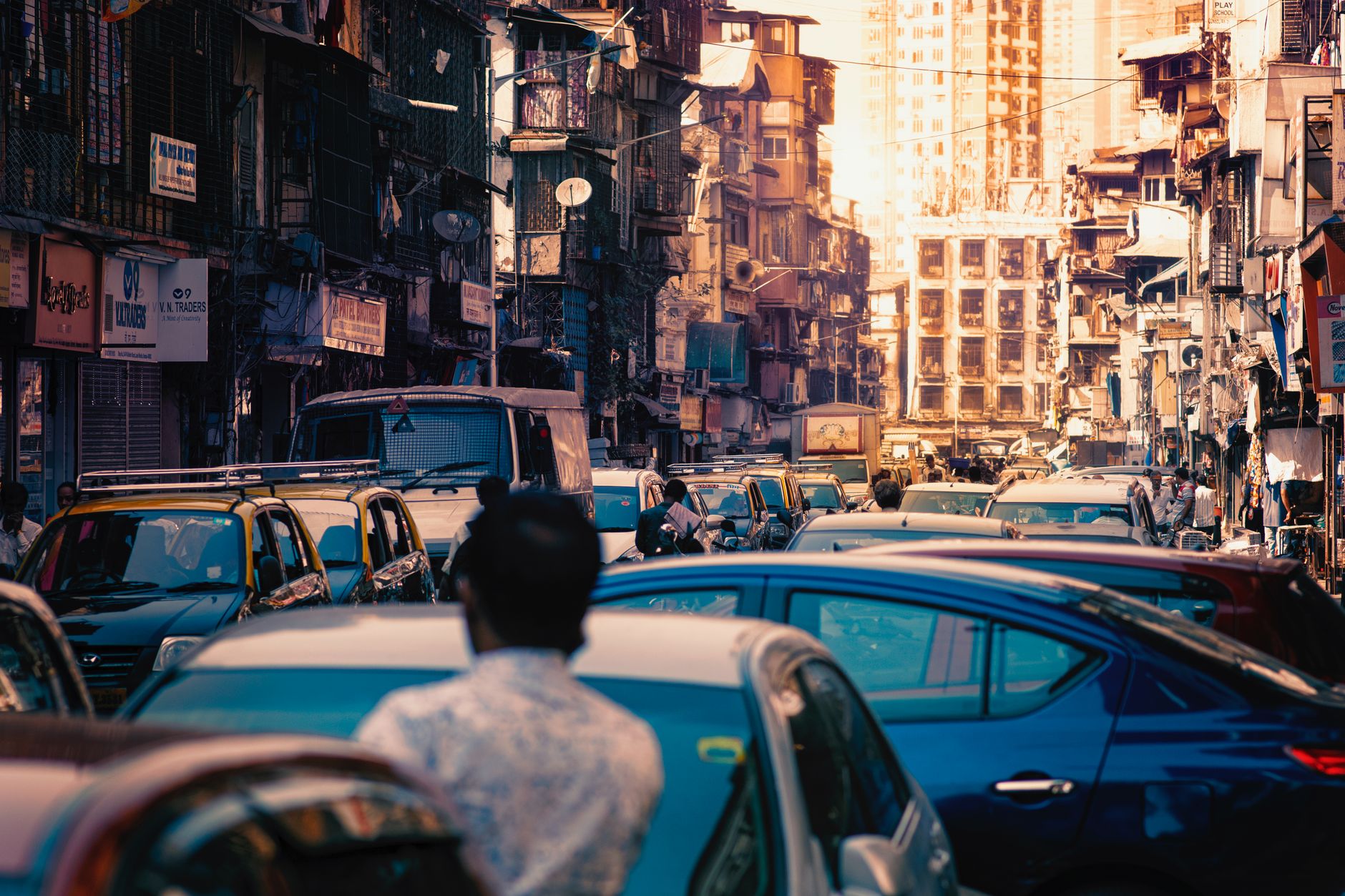 Dynamic street scene in Mumbai showcasing vibrant urban life and traffic congestion.