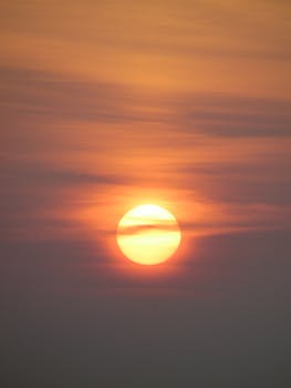 Captivating view of the sun setting amidst a dramatic cloudscape.