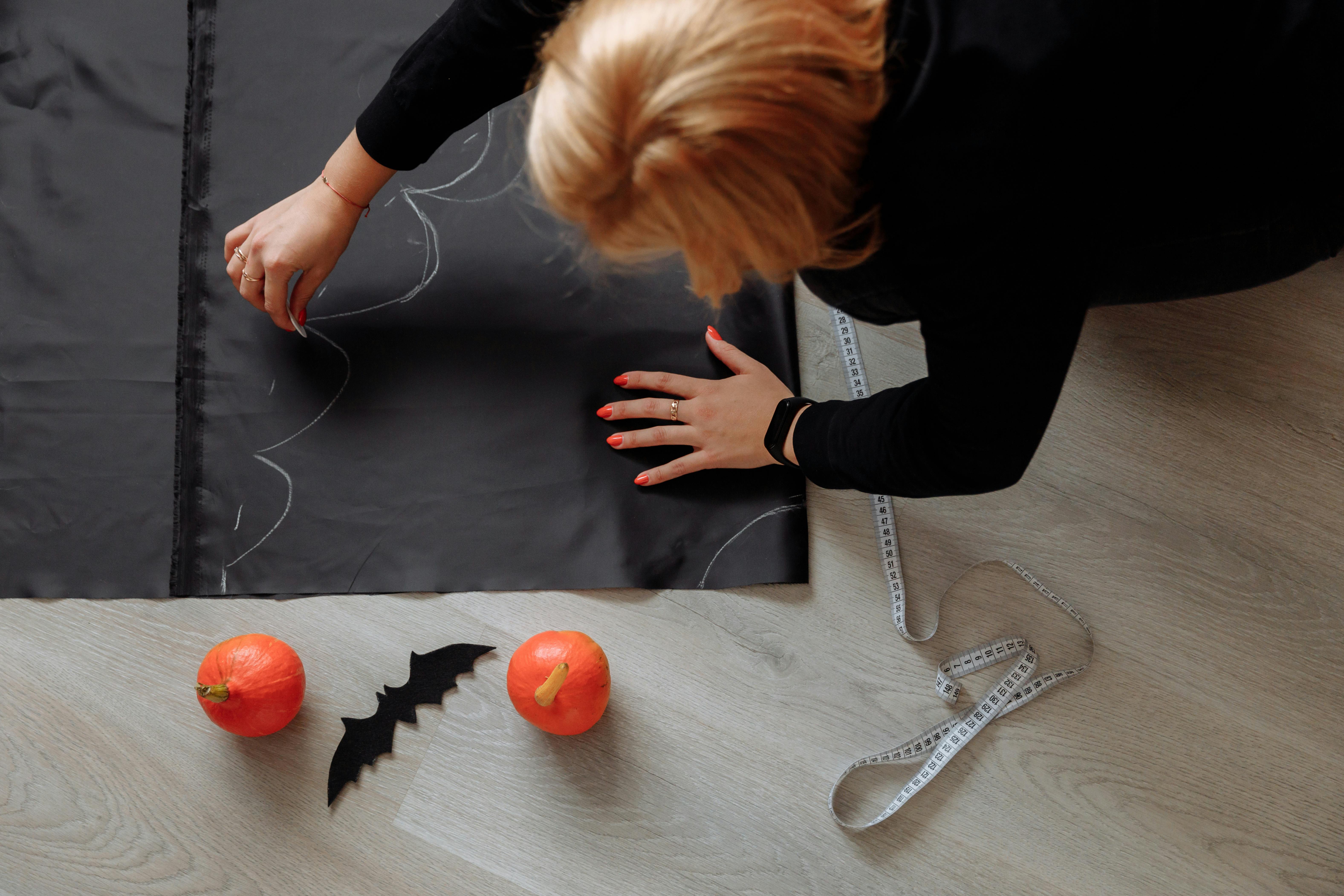 woman in black long sleeve shirt holding red apple fruit