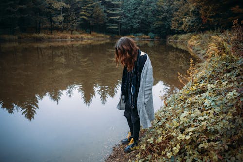 A Woman Standing Close to a Lake