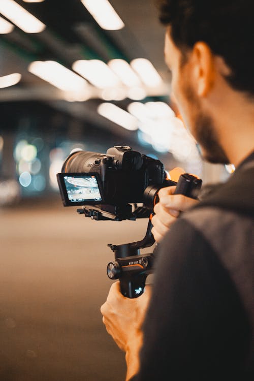 Person Holding Black Dslr Camera