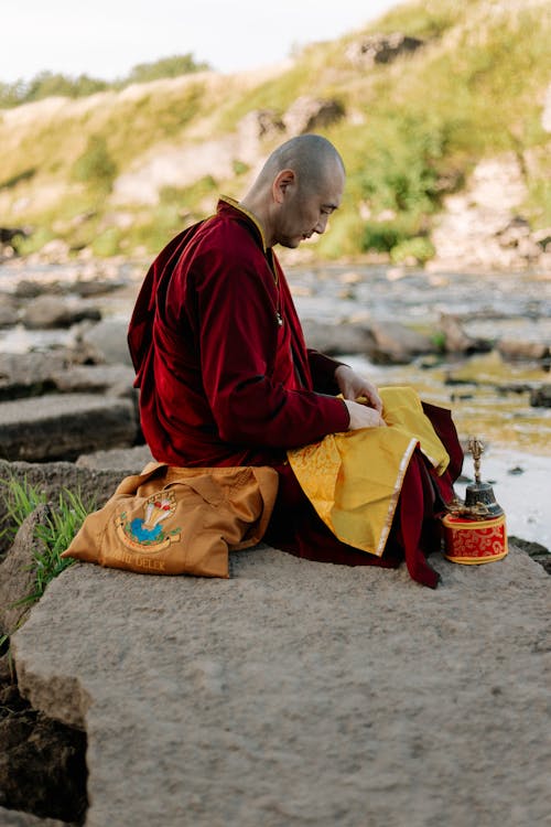 Tibetan Monk Meditating on the Riverbank