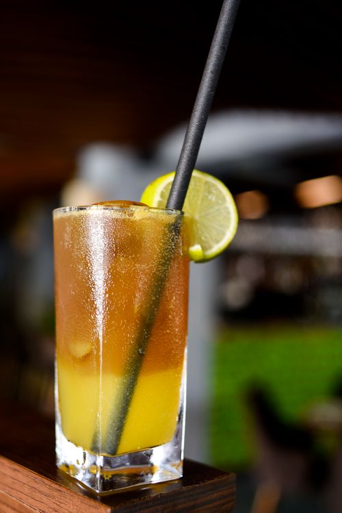 Free Chilled cocktail with lime slice and straw at a stylish bar. Stock Photo