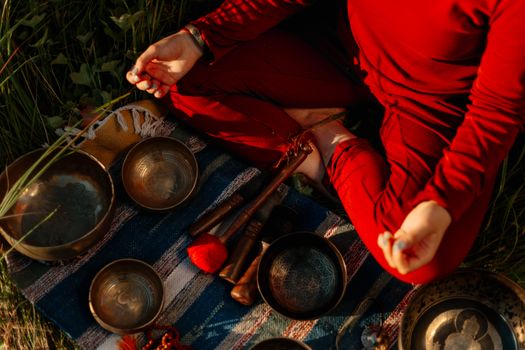 Person in Red Long Sleeve Shirt Holding Brown Wooden Handle