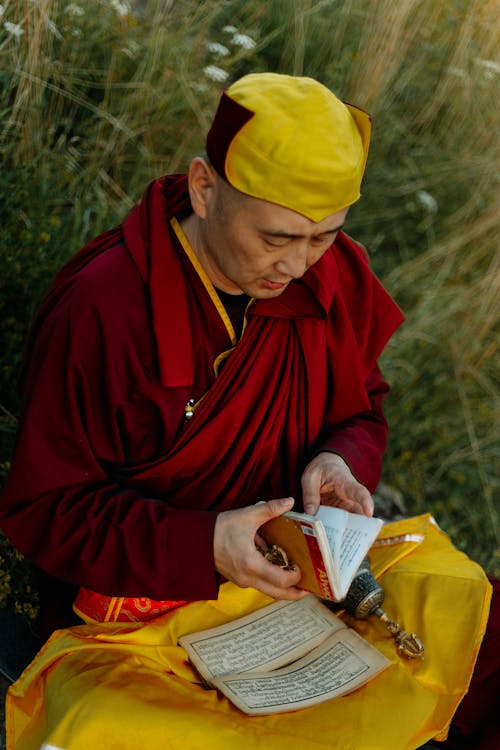 Buddhist Monk Sitting Cross-legged in a Meadow
