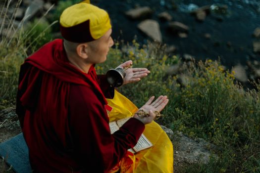 Man in Red Hoodie and Yellow Knit Cap Holding Black Camera