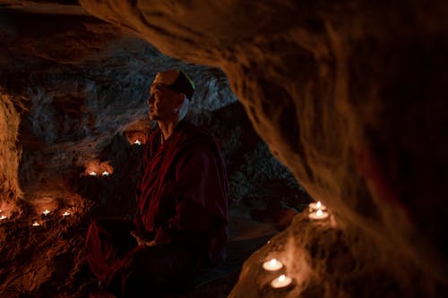 A Man Sitting Inside the Cave