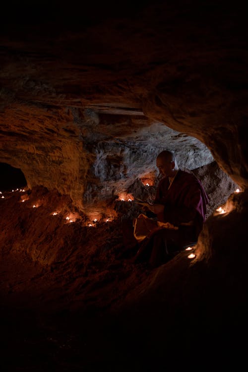 Buddhist Monk in a Cave Reading by Candlelight