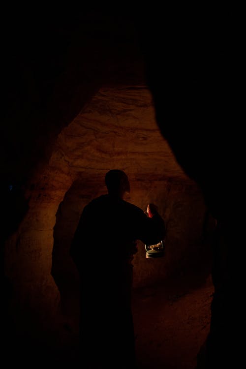 Buddhist Monk Wandering Around the Cave Corridors