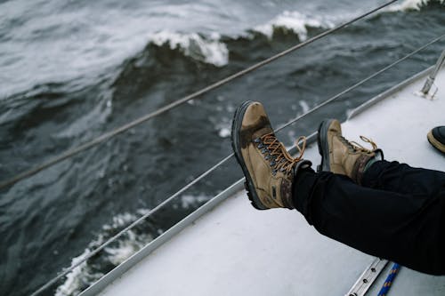 Shoes of a Man Sitting on a Sailboat
