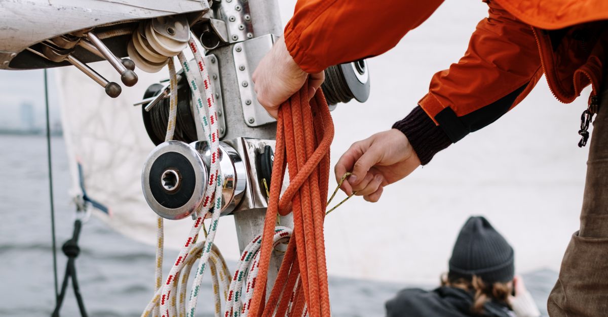 Man Ropes Ship Man in a Jacket Fixing the Ropes on the Ship · Free Stock Photo