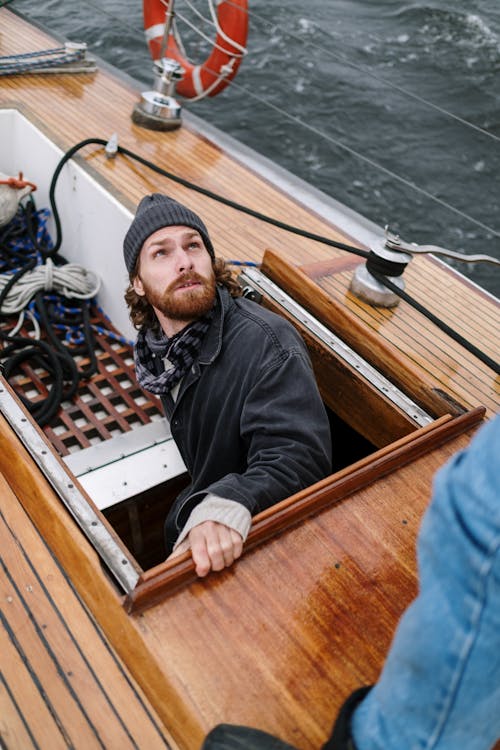 Man Coming Out from Below the Ship Deck