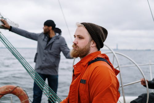 A Man in Orange Jacket Wearing a Knitted Cap