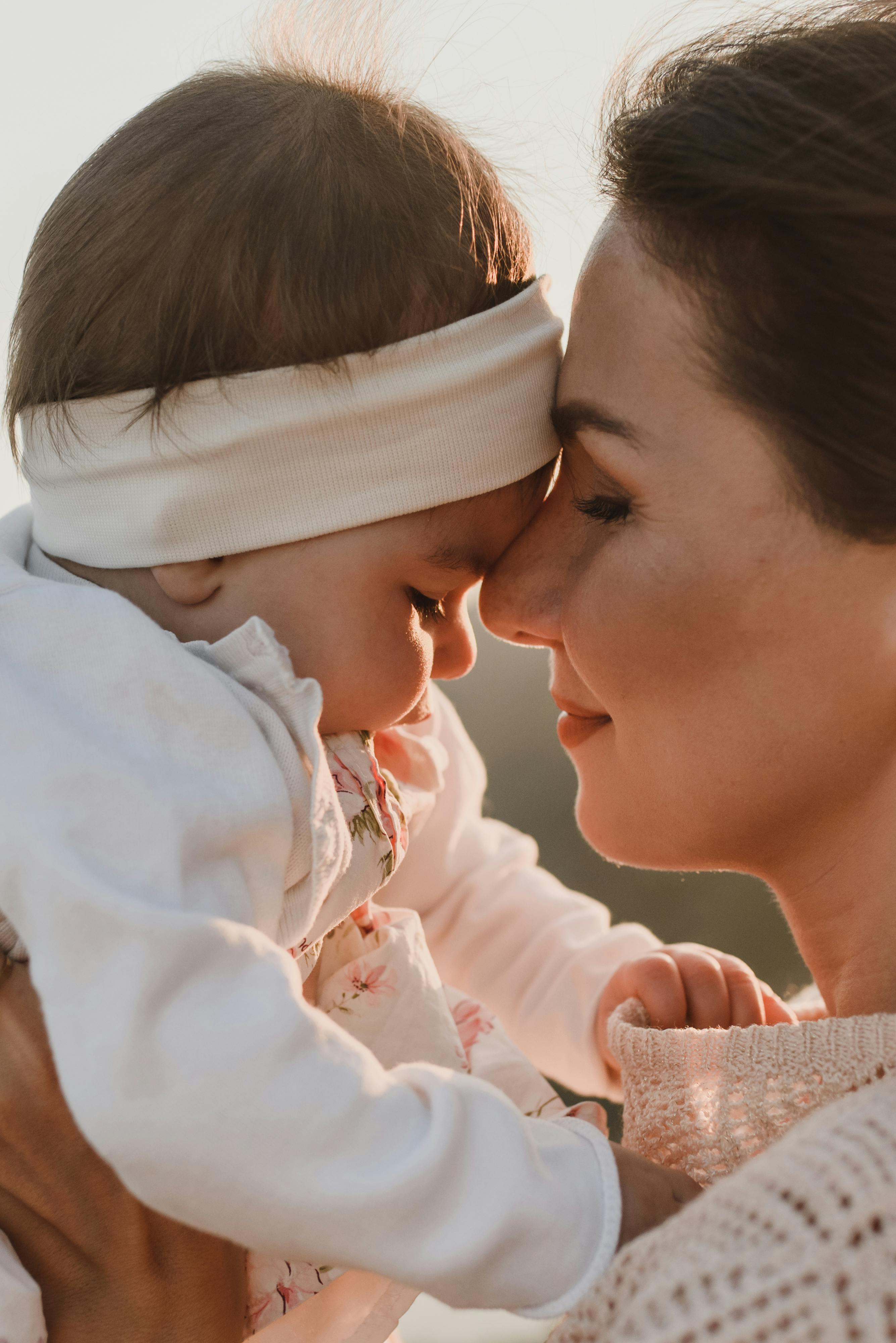 a mother and baby doing face to face