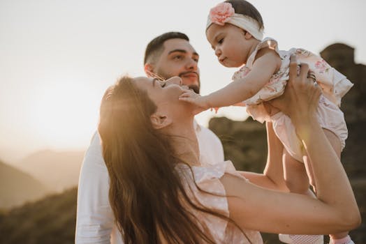 A touching moment of a family enjoying togetherness in a scenic outdoor setting during sunset.