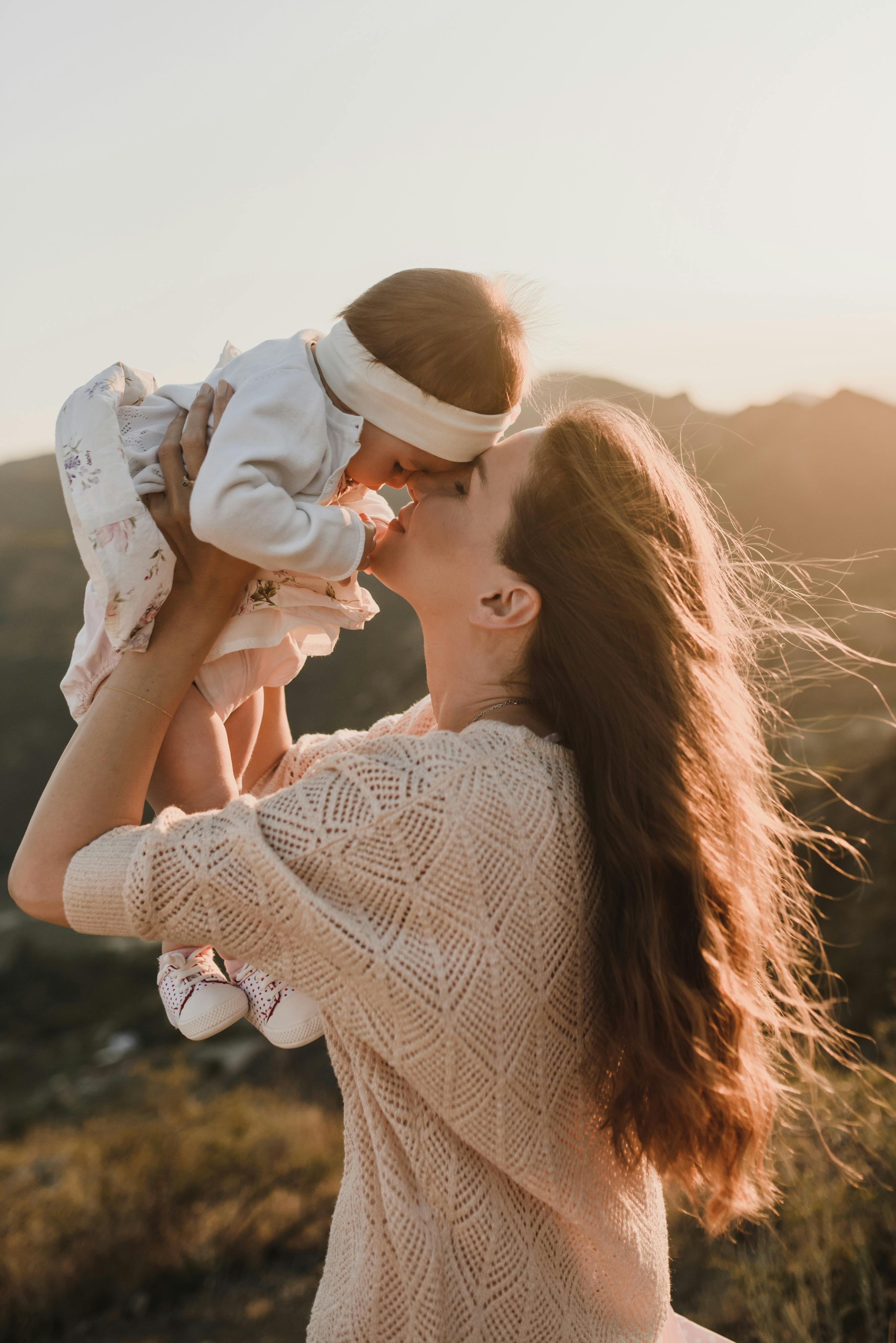 a woman raising her baby