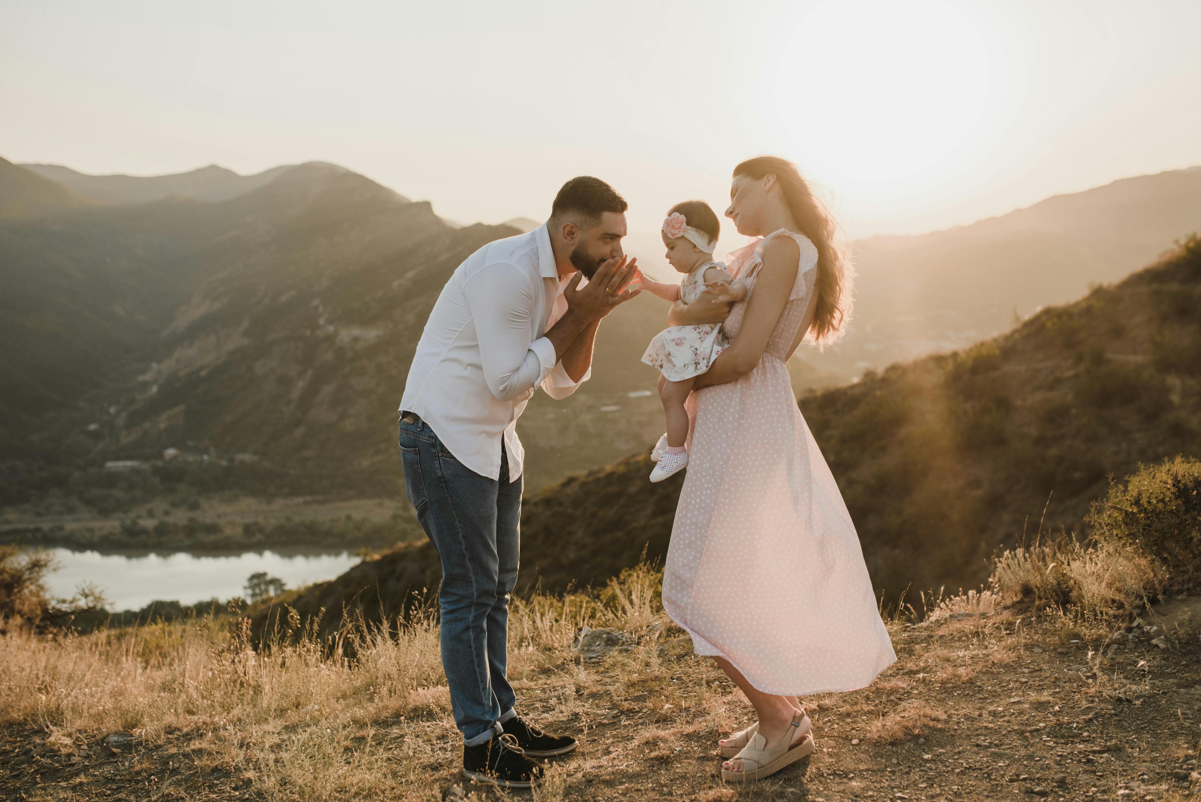 a father and mother having fun with the baby