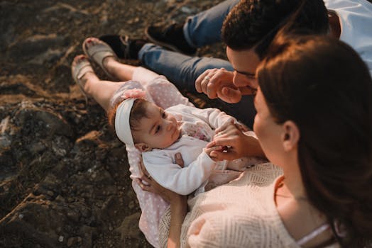 A joyful family bonding outdoors, mother and father admiring their baby.