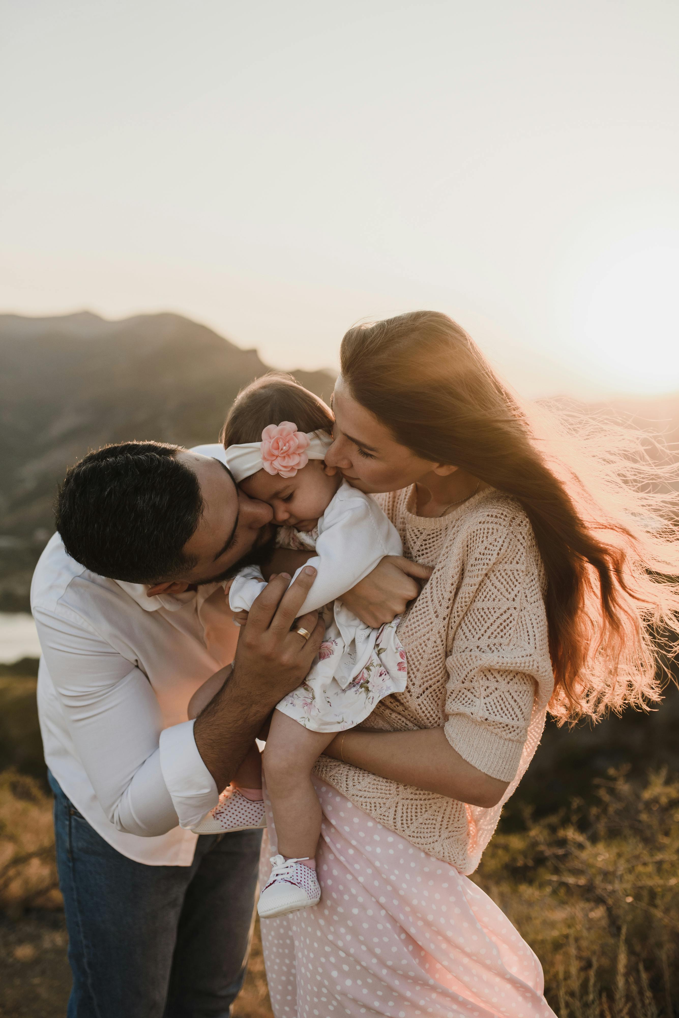 a man kissing his daughter