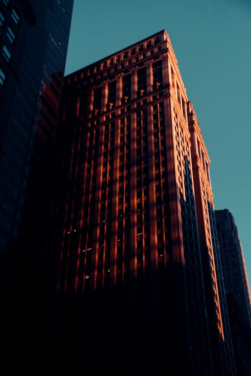 Old multistage house facades in city under blue sky