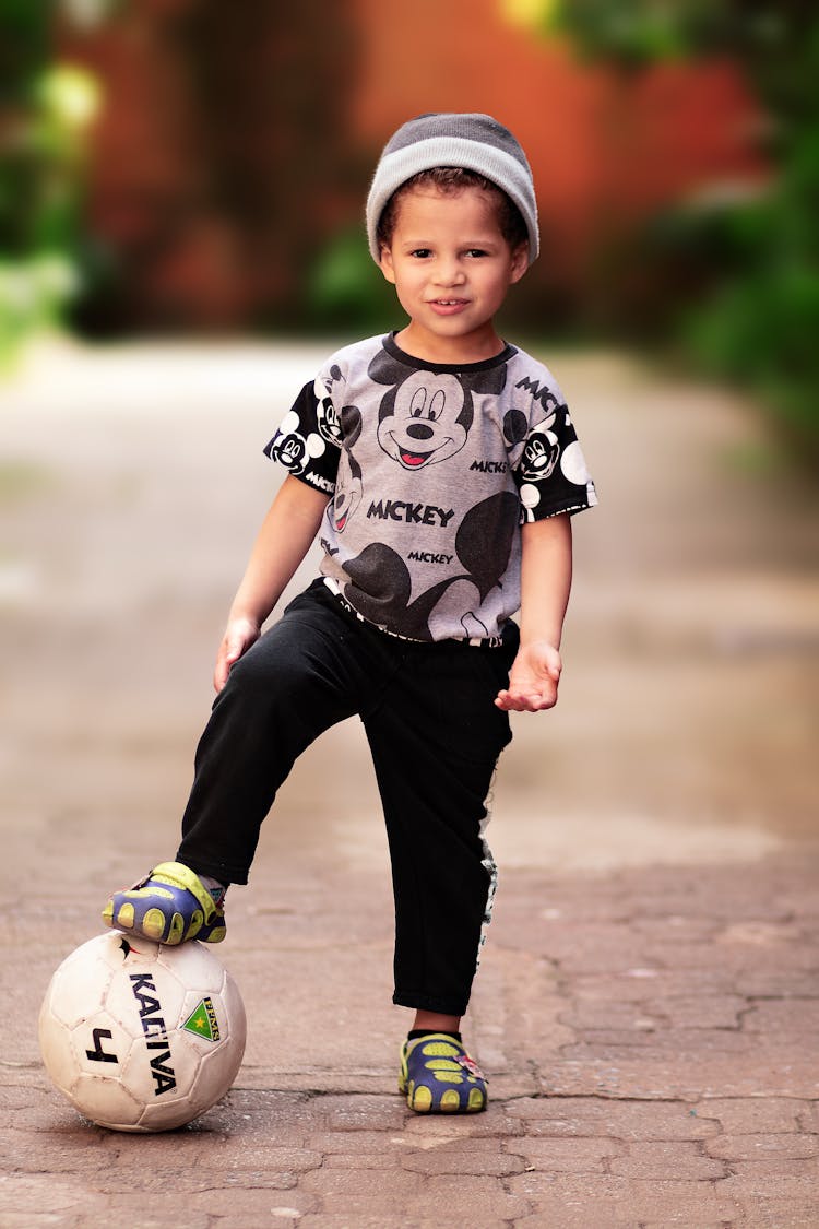 Cool Kid Standing With Football Ball